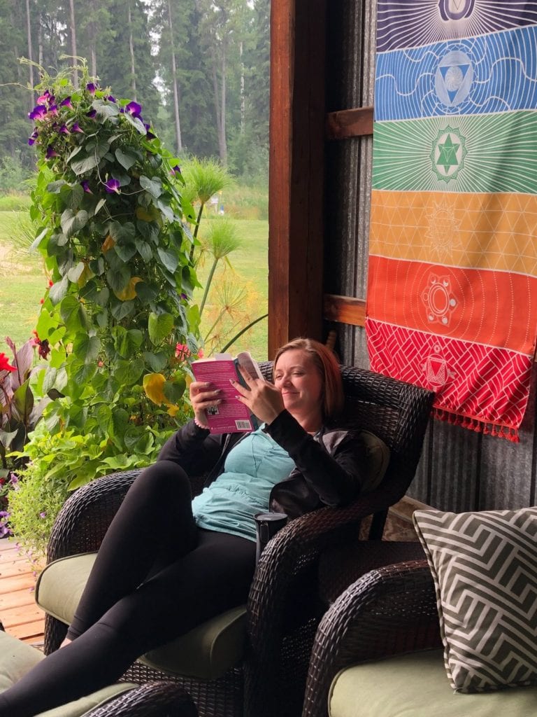 Reading a book on the patio.