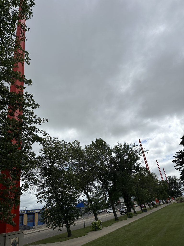 The four giant red border markers in Lloydminster on a gloomy day.