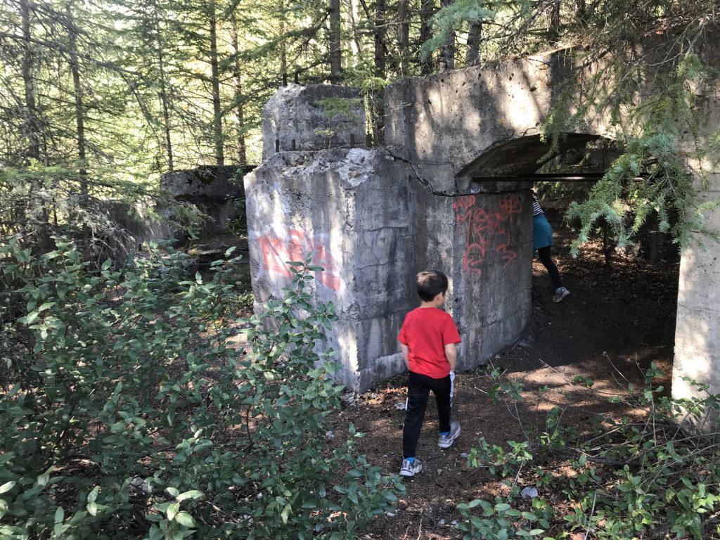 Kids exploring the Briquette Building in Bankhead ghost town in Banff National Park