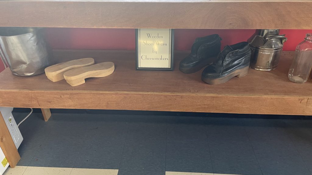 Photo of the display of "wooden shoes worn by cheesemakers" at Glenwood Cheese Factory.